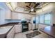 A functional kitchen with wooden cabinets, a black oven, and a stainless steel refrigerator at 1805 Mariner Dr # 52, Tarpon Springs, FL 34689