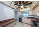 Bright kitchen with neutral cabinets, black appliances, tile floors and outdoor view through window at 1805 Mariner Dr # 52, Tarpon Springs, FL 34689