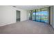 Spacious living room with plush carpet, balcony access and marina views at 1805 Mariner Dr # 52, Tarpon Springs, FL 34689