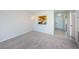 Bright living room features neutral carpet, chandelier, and open view to kitchen at 1805 Mariner Dr # 52, Tarpon Springs, FL 34689