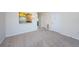 Open living room with neutral carpet, chandelier, and peek through to kitchen at 1805 Mariner Dr # 52, Tarpon Springs, FL 34689