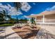 A community patio area featuring picnic tables and lush landscaping, perfect for outdoor gatherings at 1805 Mariner Dr # 52, Tarpon Springs, FL 34689