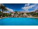 A large swimming pool surrounded by palm trees and lounge chairs for relaxing at 1805 Mariner Dr # 52, Tarpon Springs, FL 34689