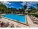 An inviting swimming pool area with lounge chairs for relaxation and soaking up the sun at 1805 Mariner Dr # 52, Tarpon Springs, FL 34689