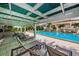 A covered patio area near a pool with lounge chairs providing a relaxing outdoor space at 1805 Mariner Dr # 52, Tarpon Springs, FL 34689