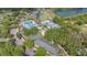 Aerial view of the community featuring a pool, tennis court, and golf course at 18111 Paradise Point Dr, Tampa, FL 33647