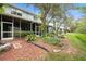 This backyard features screened patios and thoughtful landscaping at 18111 Paradise Point Dr, Tampa, FL 33647