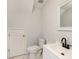 Clean half bath featuring white fixtures, a black faucet and a classic design at 18111 Paradise Point Dr, Tampa, FL 33647
