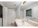 Well-lit bathroom featuring a shower-tub combo, tile floors, and vanity at 18111 Paradise Point Dr, Tampa, FL 33647