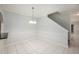 Bright dining area with ceramic tile floors, modern lighting fixture, and access to the staircase at 18111 Paradise Point Dr, Tampa, FL 33647