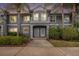 Gray two-story condo with palm trees and manicured landscaping against a colorful sunset sky at 18111 Paradise Point Dr, Tampa, FL 33647