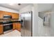 Modern kitchen with stainless steel appliances, oak cabinets, and a sleek black countertop at 18111 Paradise Point Dr, Tampa, FL 33647