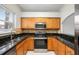 Well-equipped kitchen featuring stainless steel appliances, wooden cabinets, and stylish countertops at 18111 Paradise Point Dr, Tampa, FL 33647