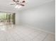 Bright living room features tile flooring, ceiling fan, and sliding glass doors to a screened-in patio at 18111 Paradise Point Dr, Tampa, FL 33647