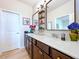 Bathroom with double sinks, quartz countertop, bronze hardware, and modern decor at 20983 Monza Loop, Land O Lakes, FL 34638