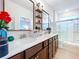 Bathroom with double sinks, quartz countertop, bronze hardware, and a large shower at 20983 Monza Loop, Land O Lakes, FL 34638