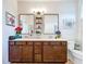 Bathroom with double sinks, quartz countertop, dual mirrors, and bronze hardware at 20983 Monza Loop, Land O Lakes, FL 34638