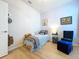 Bedroom with a single bed, neutral decor, and wood-look laminate flooring at 20983 Monza Loop, Land O Lakes, FL 34638