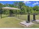 Community dog park with shaded seating and pet-friendly amenities, offering a great space for residents and their furry friends at 20983 Monza Loop, Land O Lakes, FL 34638