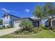 Charming single-Gathering home with a well-manicured lawn, mature trees, and attached one-car garage at 20983 Monza Loop, Land O Lakes, FL 34638