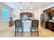 Kitchen island with pendant lighting, modern appliances, and convenient seating at 20983 Monza Loop, Land O Lakes, FL 34638