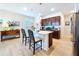 A bright kitchen showcasing a center island with bar seating, modern lighting, and wooden cabinets at 20983 Monza Loop, Land O Lakes, FL 34638