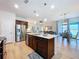 Open-concept kitchen with island, modern appliances, and easy access to the dining and living areas at 20983 Monza Loop, Land O Lakes, FL 34638