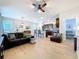 Spacious living room with hardwood floors, a ceiling fan, and an open layout to the kitchen at 20983 Monza Loop, Land O Lakes, FL 34638