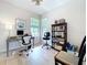 Bright home office featuring a desk, ergonomic chair, and shelving for a comfortable workspace at 20983 Monza Loop, Land O Lakes, FL 34638