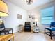 Cozy sitting room with a comfortable black armchair, lamp, and accent tables, perfect for relaxation at 20983 Monza Loop, Land O Lakes, FL 34638