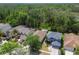 Aerial view of a neighborhood highlighting roof lines and lush surrounding trees at 21840 Waverly Shores Ln, Land O Lakes, FL 34637