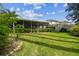 Lush backyard featuring a screened patio, mature landscaping, and privacy fencing at 21840 Waverly Shores Ln, Land O Lakes, FL 34637