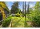 Private backyard with a screened patio, mature trees, and well-maintained landscaping at 21840 Waverly Shores Ln, Land O Lakes, FL 34637