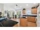 Spacious kitchen with dark countertops, natural cabinets, and a breakfast bar with seamless flow to other rooms at 21840 Waverly Shores Ln, Land O Lakes, FL 34637