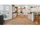 Spacious kitchen with light wood cabinetry, black countertops, and large tiled flooring for a sleek design at 21840 Waverly Shores Ln, Land O Lakes, FL 34637