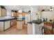 Well-equipped kitchen with granite countertops, wooden cabinets, breakfast bar, and modern appliances at 21840 Waverly Shores Ln, Land O Lakes, FL 34637