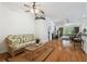 Cozy living room featuring hardwood floors, ceiling fan, and seamless flow to the outdoor patio at 21840 Waverly Shores Ln, Land O Lakes, FL 34637