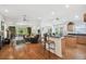 Open concept living area with hardwood floors, bar seating, and seamless flow to the outdoor patio at 21840 Waverly Shores Ln, Land O Lakes, FL 34637