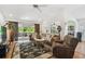 Cozy living room with comfortable seating, sliding glass doors to the lanai, and views of the dining area at 21840 Waverly Shores Ln, Land O Lakes, FL 34637