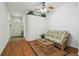 Bright living room featuring hardwood floors, ceiling fan, and easy access to the main entrance at 21840 Waverly Shores Ln, Land O Lakes, FL 34637