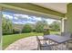 Backyard view of patio with outdoor seating and landscaping at 22338 Bartholdi Cir, Land O Lakes, FL 34639