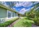 Exterior shot of house with a paver walkway leading to the backyard at 22338 Bartholdi Cir, Land O Lakes, FL 34639