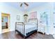 Bedroom with hardwood floors and a vintage metal frame bed at 22338 Bartholdi Cir, Land O Lakes, FL 34639