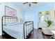 Comfortable bedroom featuring hardwood floors, ceiling fan, and sitting area at 22338 Bartholdi Cir, Land O Lakes, FL 34639