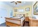 Comfortable bedroom features wood floors, fan, natural light, and a full size bed at 22338 Bartholdi Cir, Land O Lakes, FL 34639