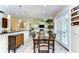 Dining area with wood table, seating for six, opening into a living area with fireplace at 22338 Bartholdi Cir, Land O Lakes, FL 34639