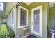 Exterior view of covered porch with window and door at 22338 Bartholdi Cir, Land O Lakes, FL 34639