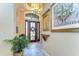 Beautiful foyer featuring tile floors, decorative lighting, and a decorative front door at 22338 Bartholdi Cir, Land O Lakes, FL 34639