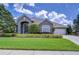 Charming home featuring well manicured lawn, stone accents, and beautiful mature landscaping at 22338 Bartholdi Cir, Land O Lakes, FL 34639
