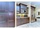 Kitchen pantry boasts built-in stainless appliances, dark wood cabinetry, and granite counters at 22338 Bartholdi Cir, Land O Lakes, FL 34639